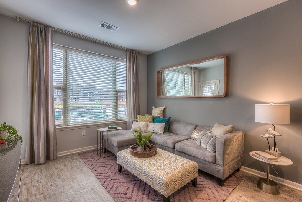 a living room with a couch and a table  at Waterside Residences on Quivira, Lenexa, KS