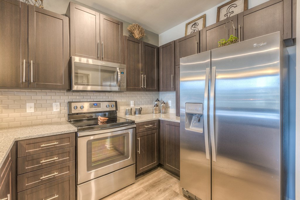 a kitchen with stainless steel appliances  at Waterside Residences on Quivira, Lenexa, Kansas