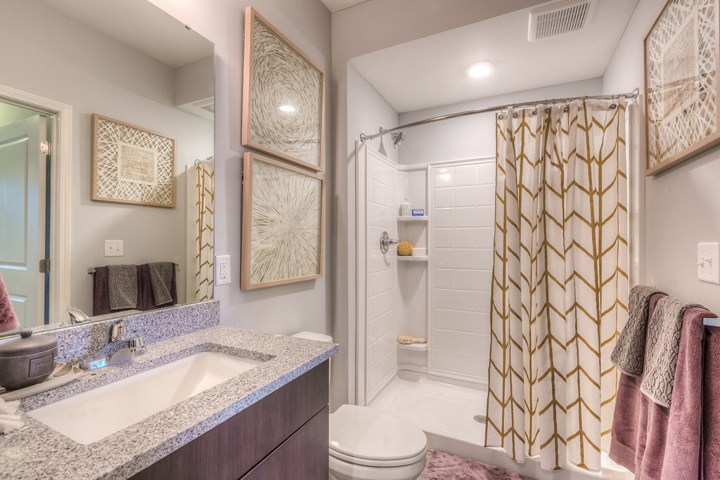 a bathroom with a shower and a sink and a toilet  at Waterside Residences on Quivira, Kansas