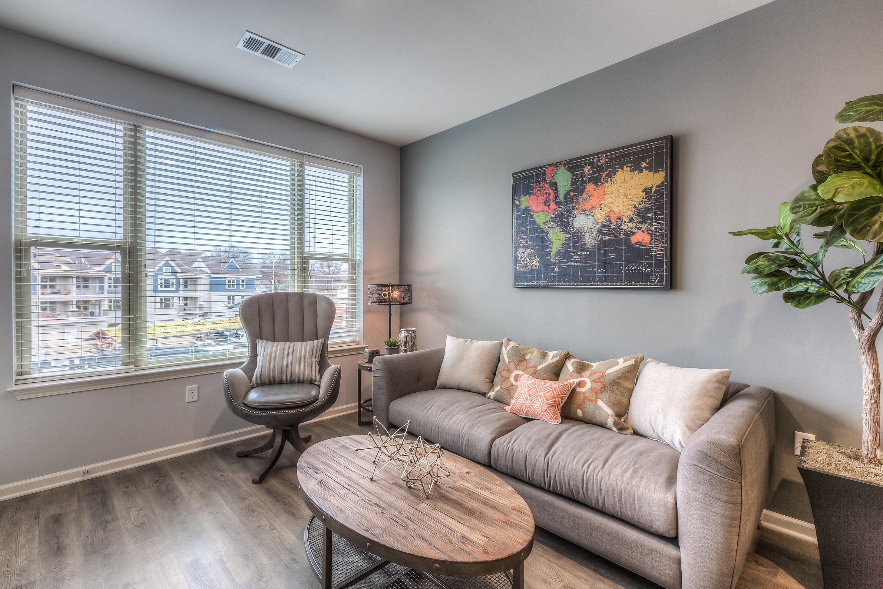a living room with a couch and a chair and a coffee table  at Waterside Residences on Quivira, Kansas, 66215