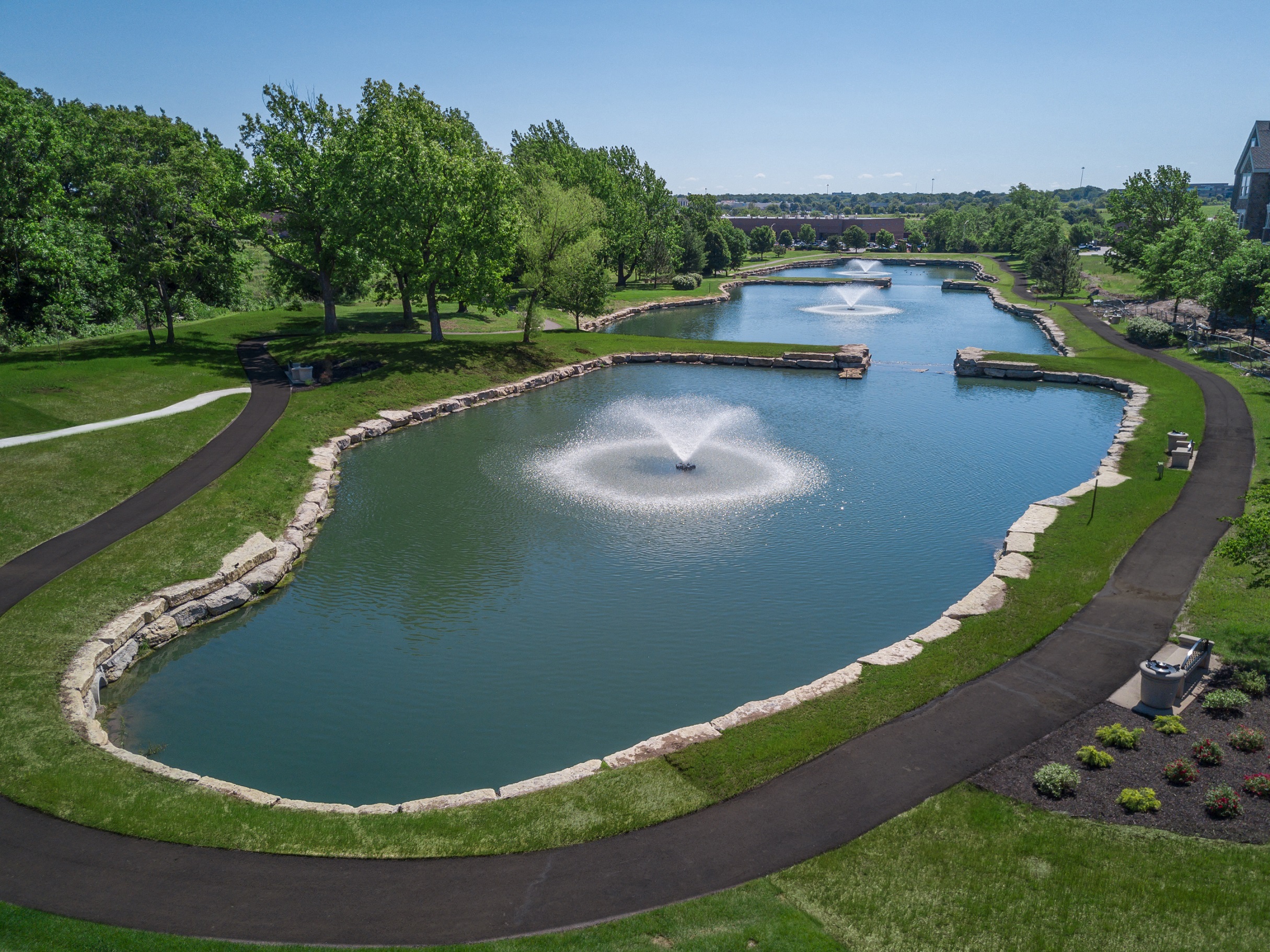 Lenexa KS Apartments-Waterside Residences at Quivira Apartments Neighboring Lake With Fountain And Surrounding Greenery  at Waterside Residences on Quivira, Lenexa, KS, 66215