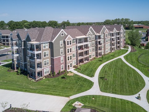 an aerial view of an apartment complex with green grass and trees an aerial view of an apartment complex with green grass and trees at Waterside Residences on Quivira, Kansas