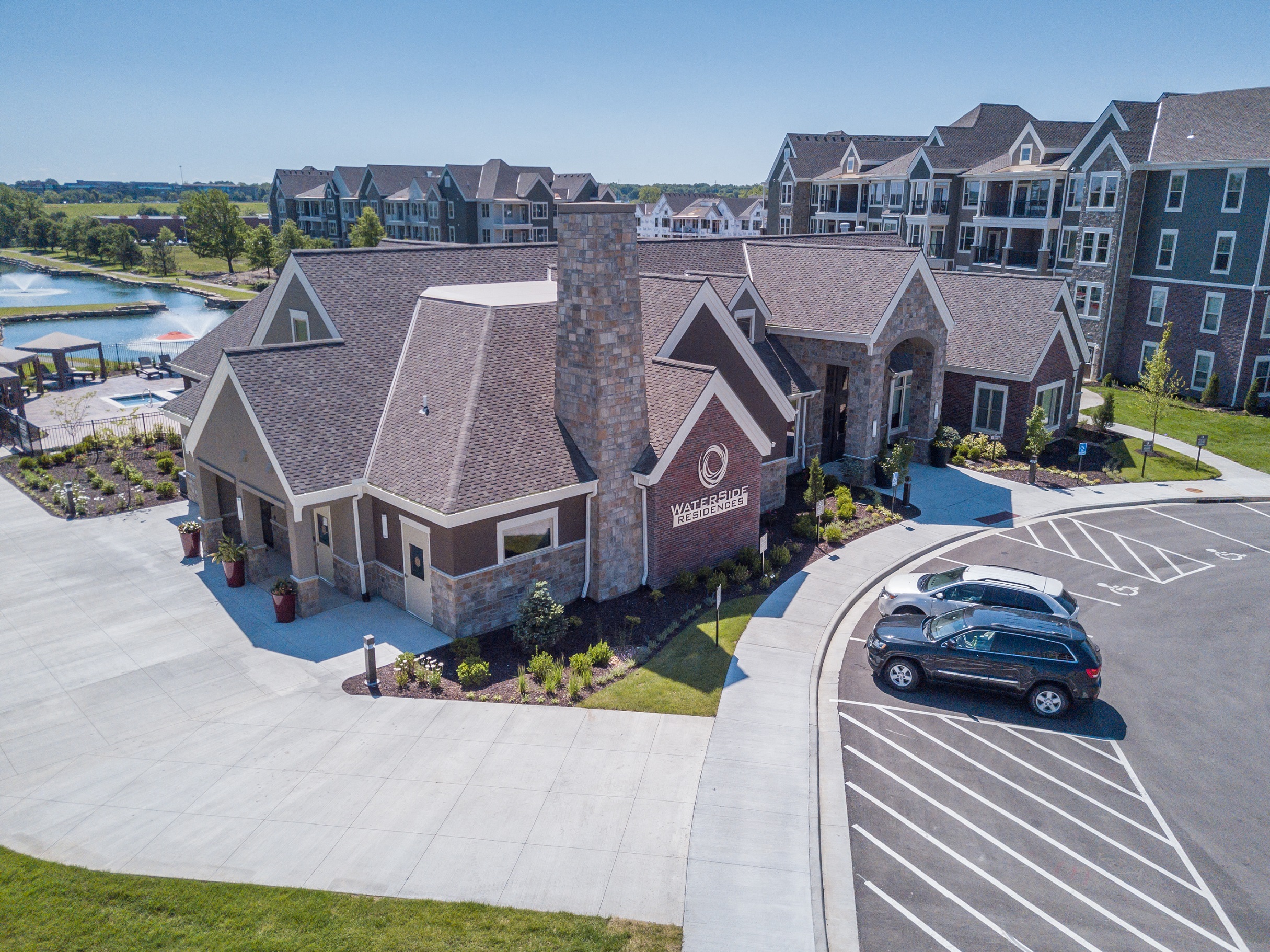 an aerial view of the community clubhouse with guest parking  at Waterside Residences on Quivira, Lenexa, Kansas