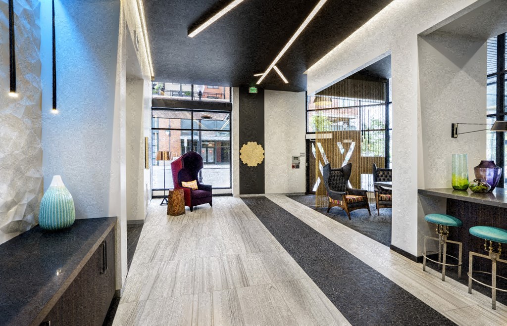 a woman sitting in a chair in a lobby of a building