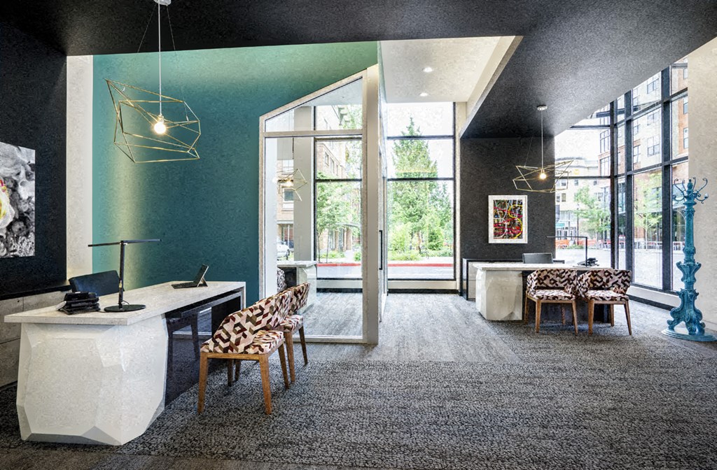 a large room with a desk and chairs and a large window