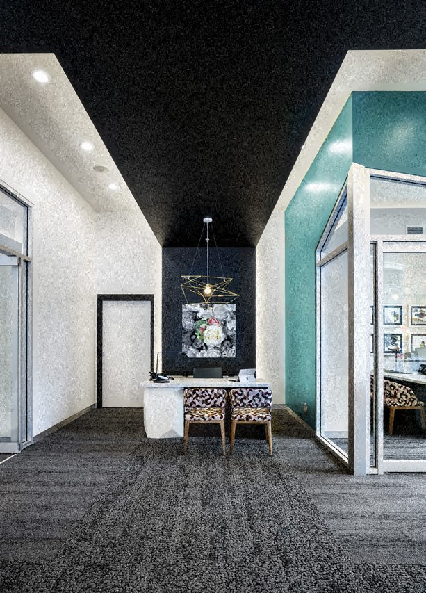 a long hallway with a table and chairs and a black ceiling