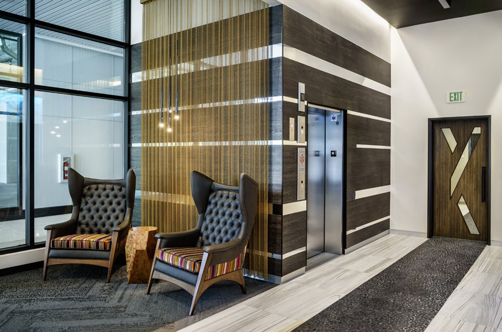 two chairs in a lobby next to a elevators