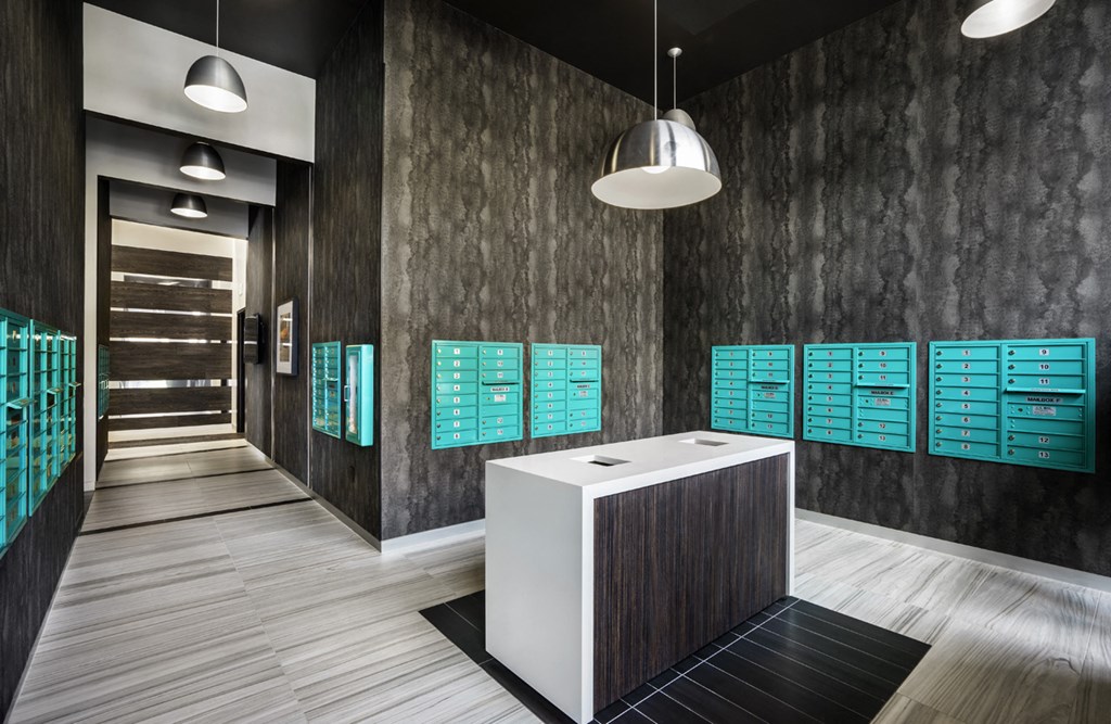 a large white desk in a room with green cabinets