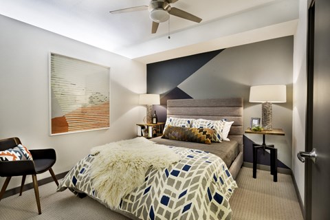 a bedroom with a large bed and a ceiling fan