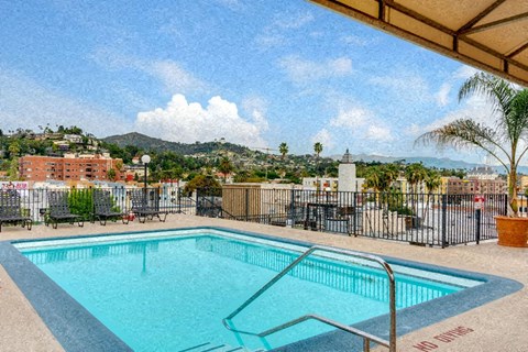 a swimming pool at a resort with a city in the background