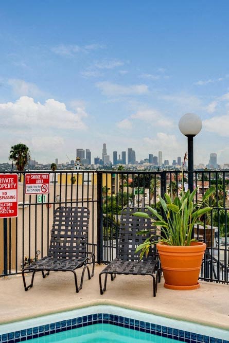 two chairs sitting next to a swimming pool