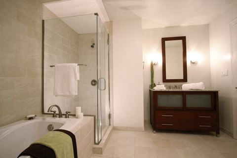 a bathroom with a tub and a shower and a sink