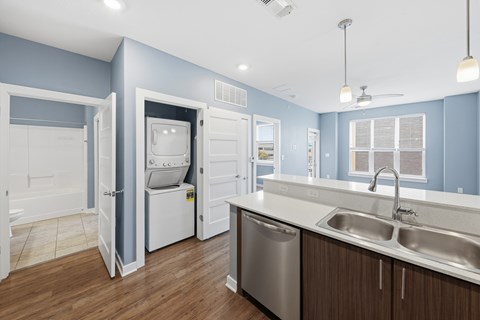 A kitchen with a blue wall and white appliances.