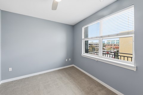 A room with a window overlooking a cityscape.