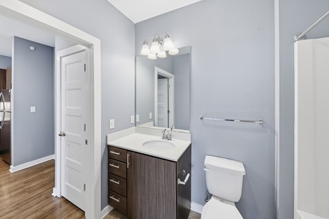 A bathroom with a white toilet, sink, and a white door.