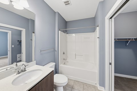 A bathroom with a white toilet and a white shower stall.