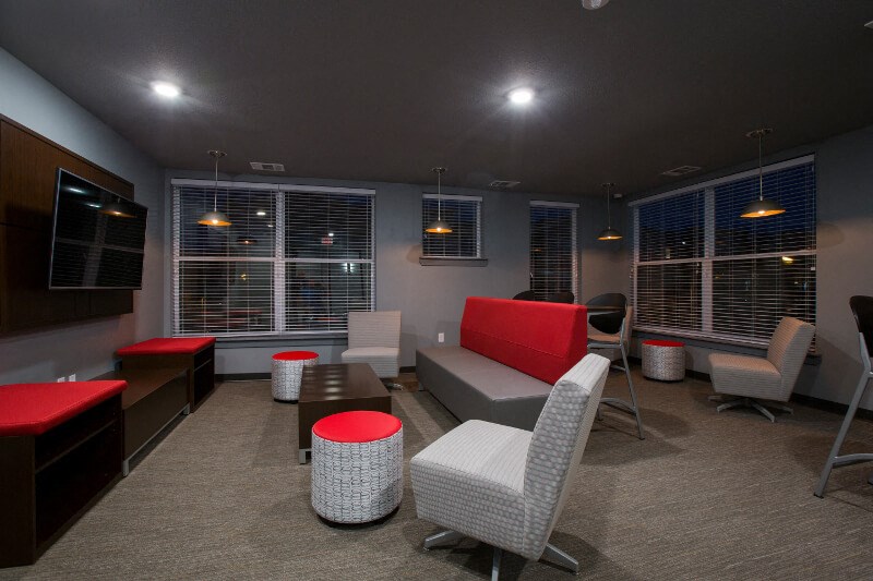 a lounge room with couches chairs and a table