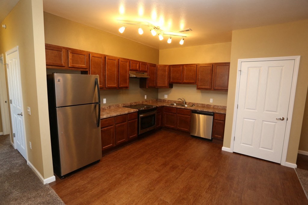 a kitchen with stainless steel appliances and wooden cabinets