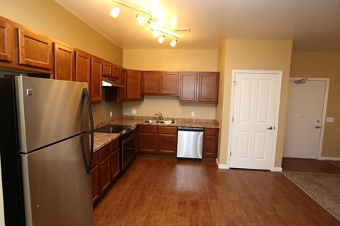 a kitchen with stainless steel appliances and wooden cabinets