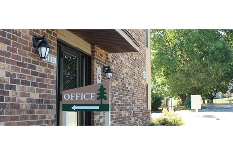 the sign for the office is in front of the building