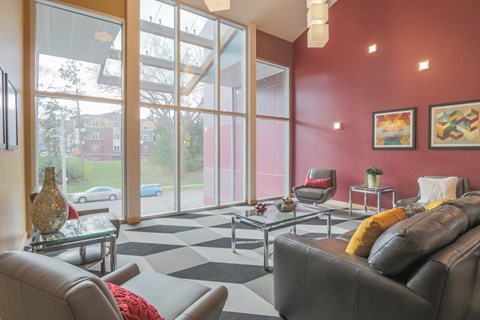 a living room with leather furniture and large windows