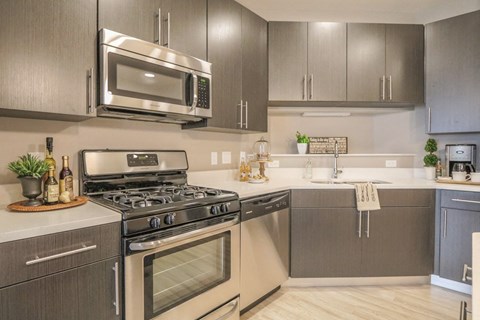 a kitchen with stainless steel appliances and a microwave