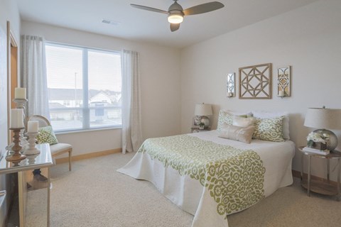a bedroom with a bed and a ceiling fan