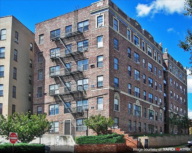 A red brick building with a fire escape on the side.