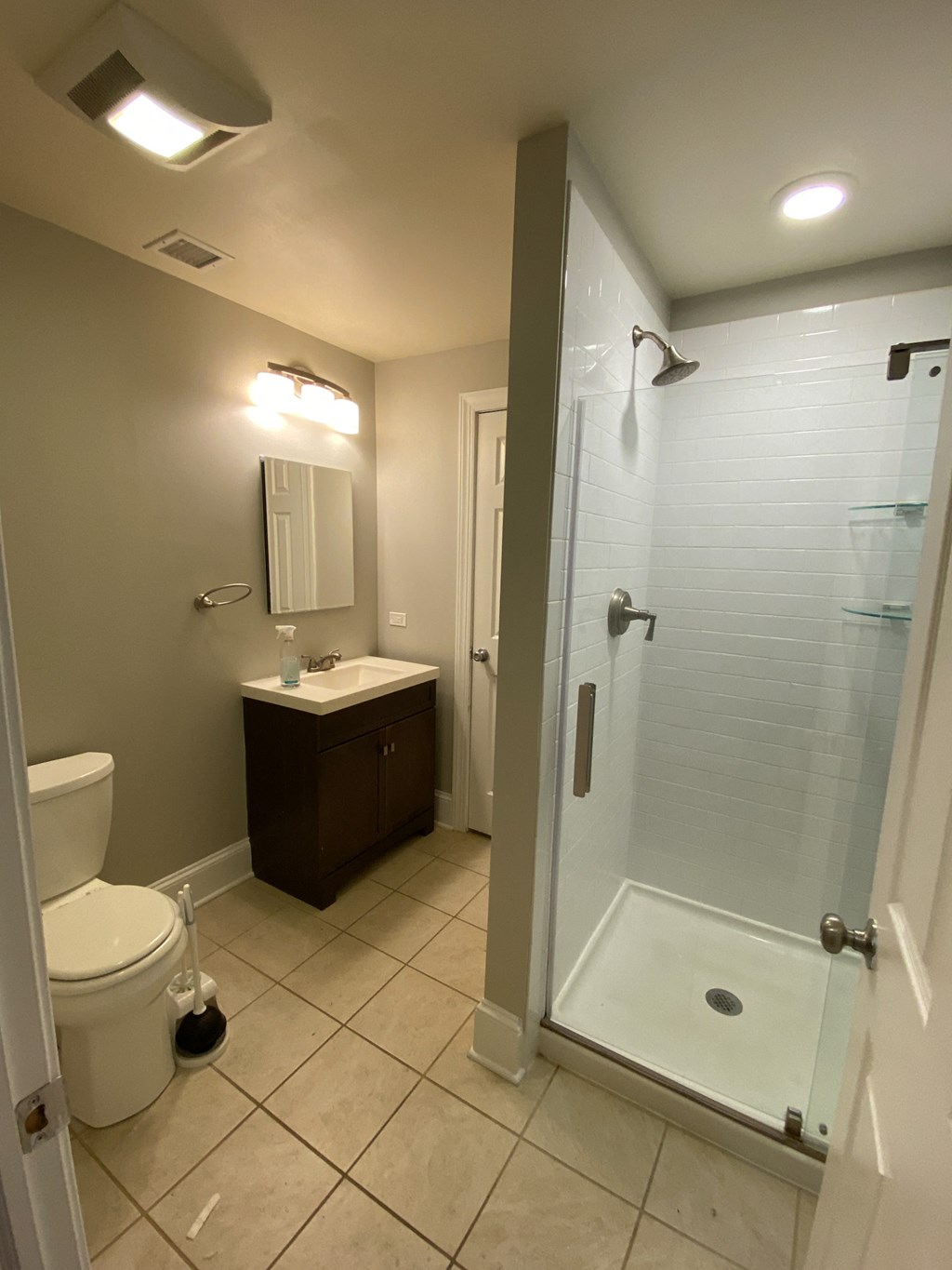 a bathroom with a shower and a sink and a toilet