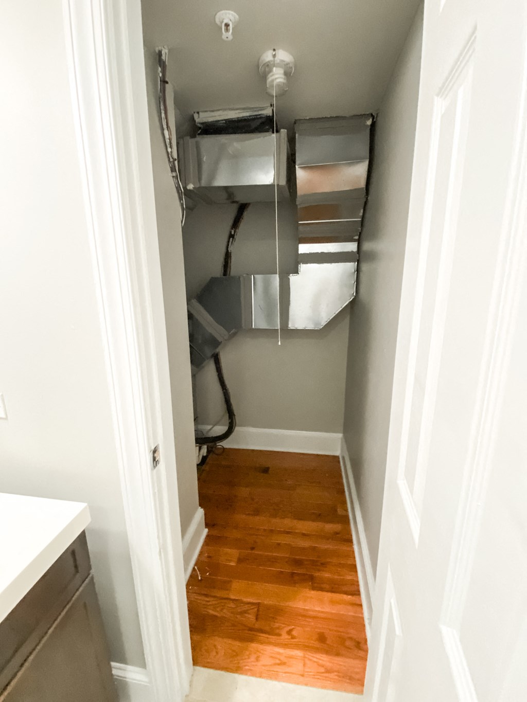 an empty closet in a small room with a wood floor