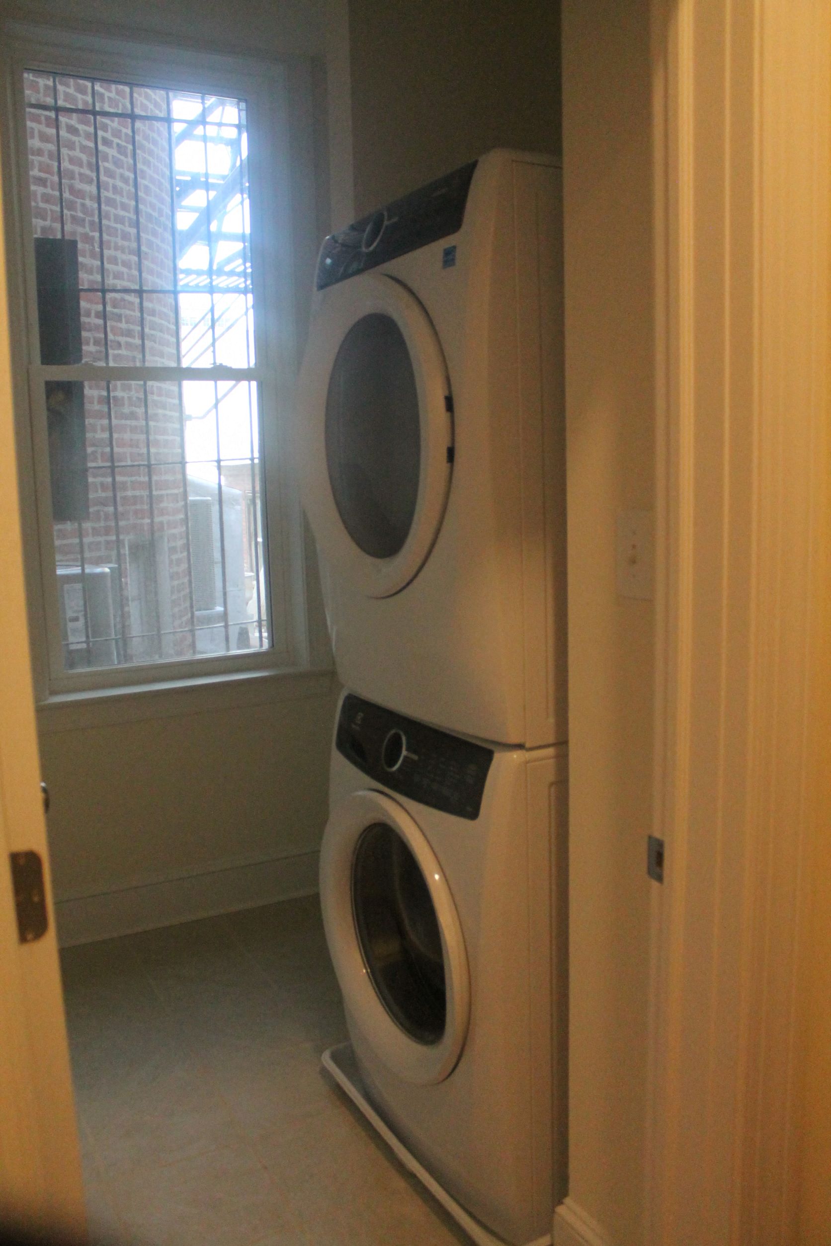 a front loading washer and dryer in a laundry room