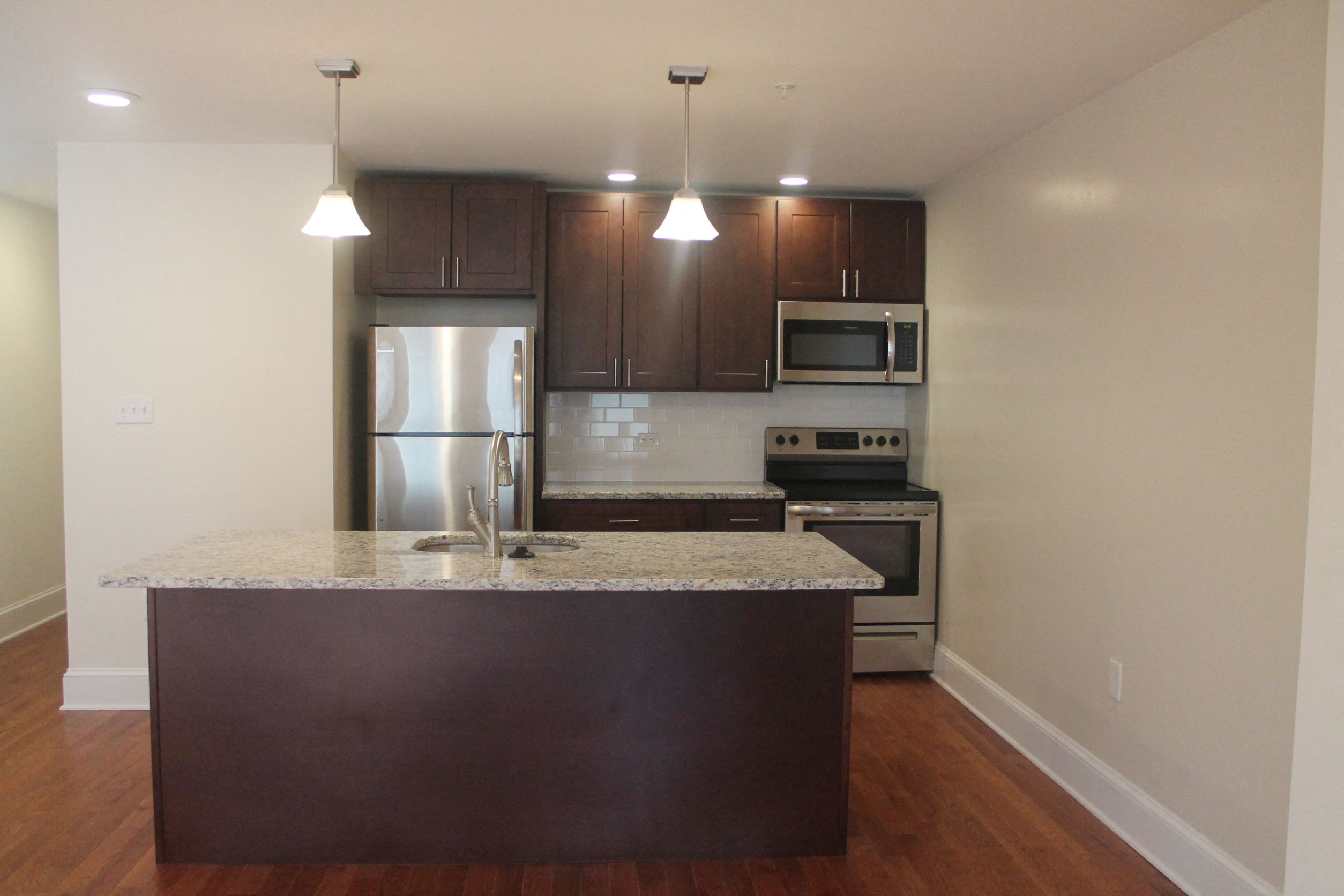 a kitchen with stainless steel appliances and a granite counter top