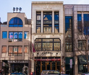 a large building with cars parked in front of it