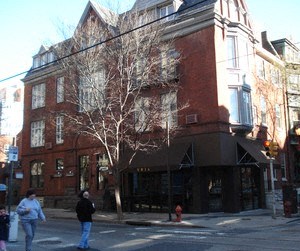 a large brick building on the corner of a street