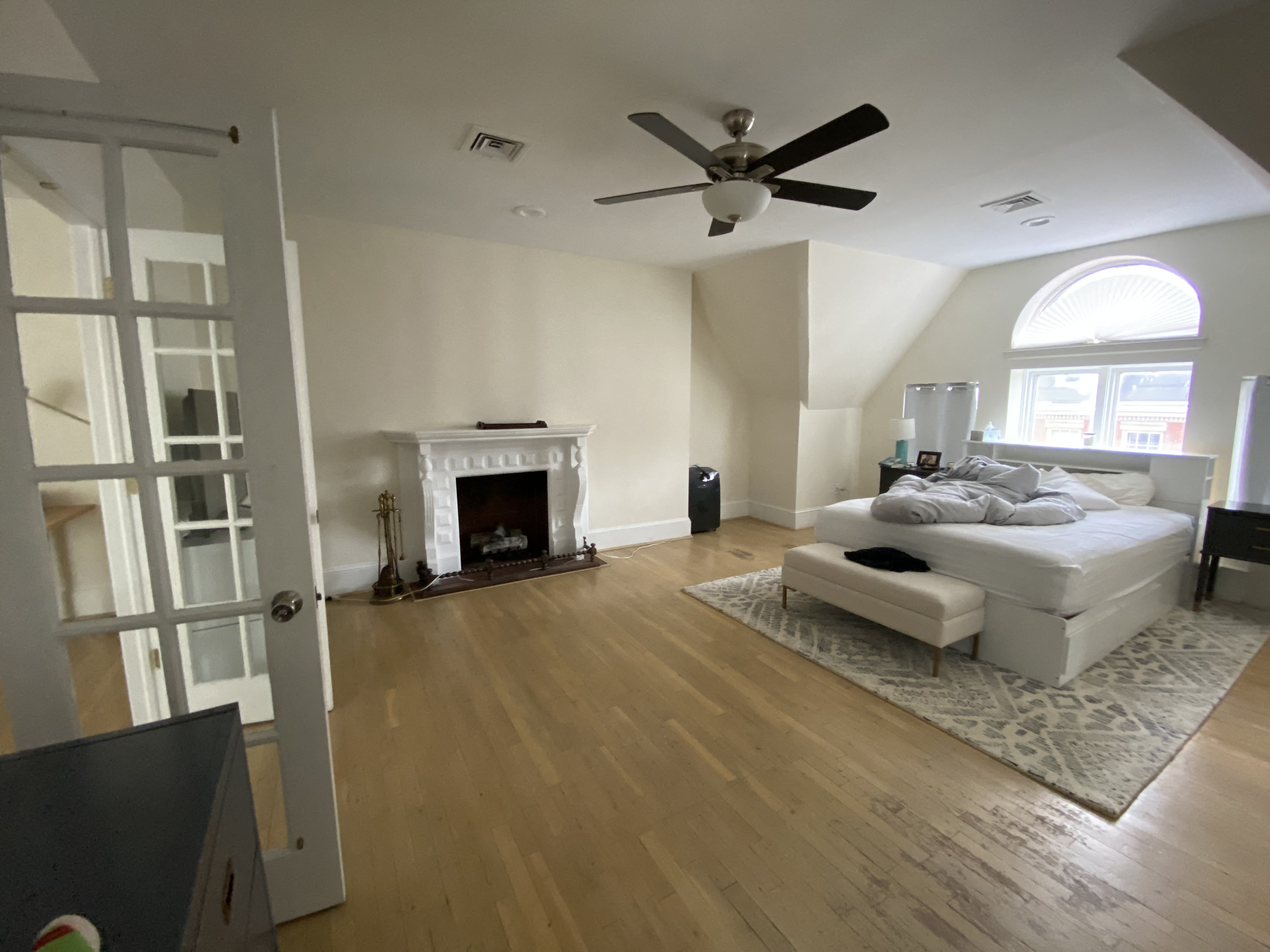 a living room with a white couch and a fireplace