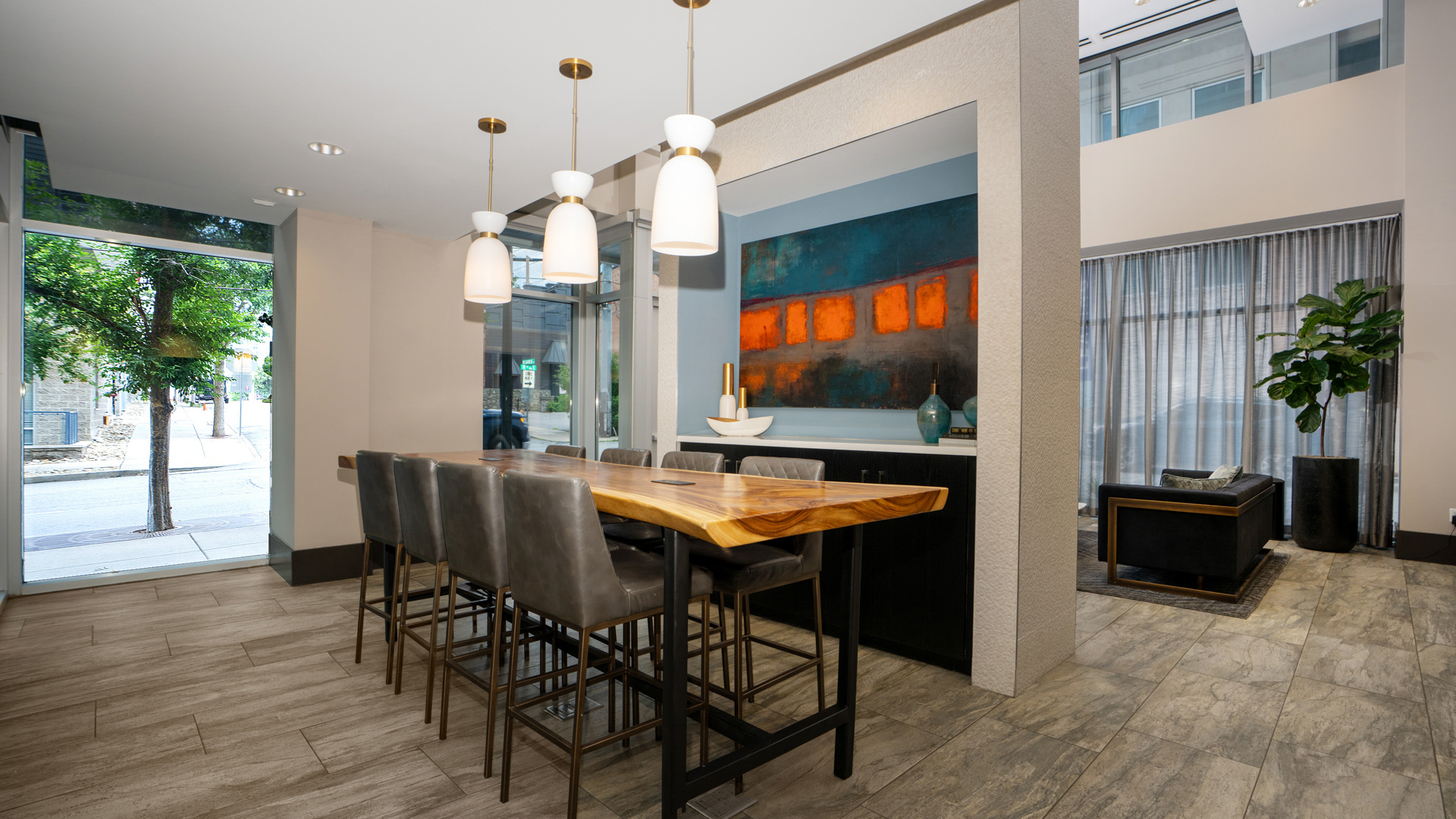 A dining room with a long table and chairs.