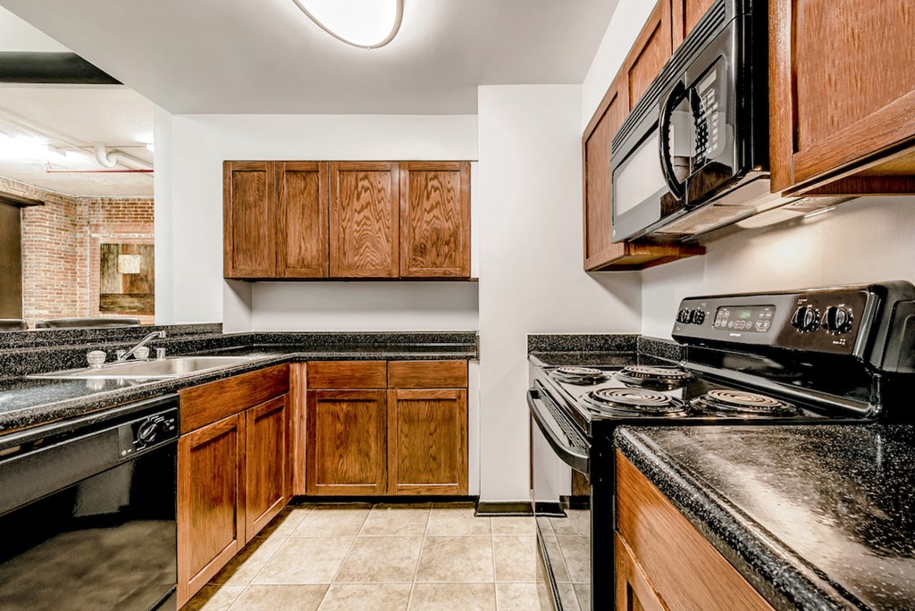 a kitchen with a stove microwave and sink