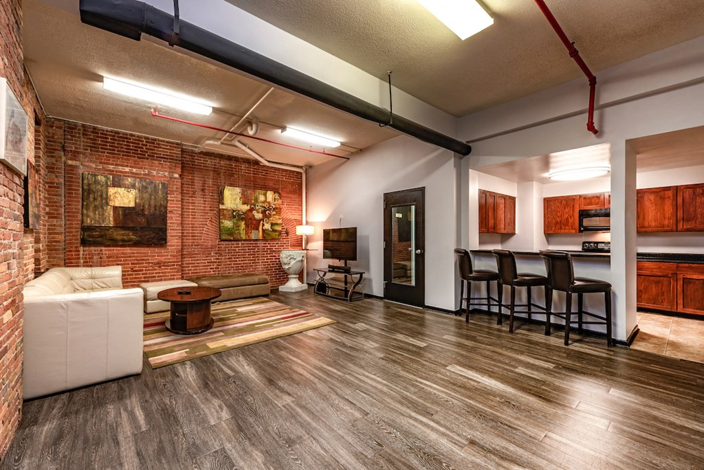 a living room with a brick wall and a couch and a table
