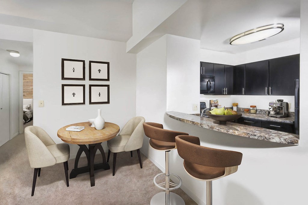 a dining room and kitchen in a hotel room with a counter