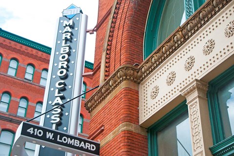 a sign on the side of a red brick building