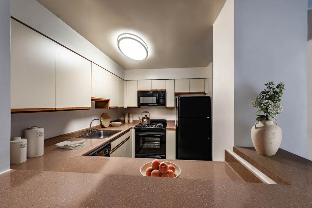 a kitchen with a bowl of fruit on the counter