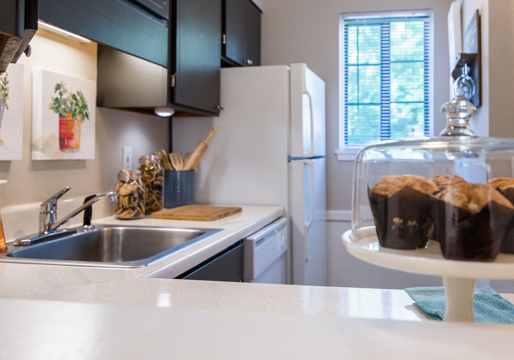 a kitchen with a sink and a refrigerator