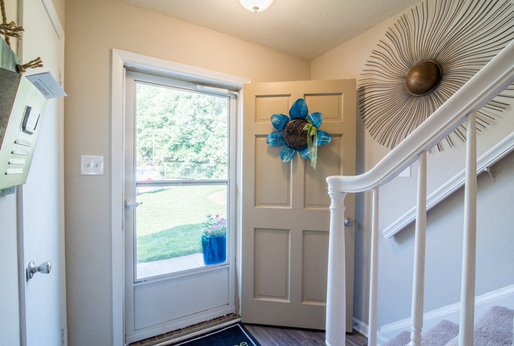 the entryway of a house with a door and a window