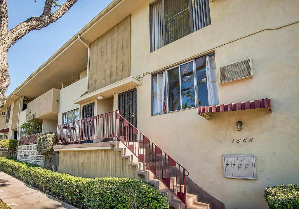 an apartment building with stairs and a window