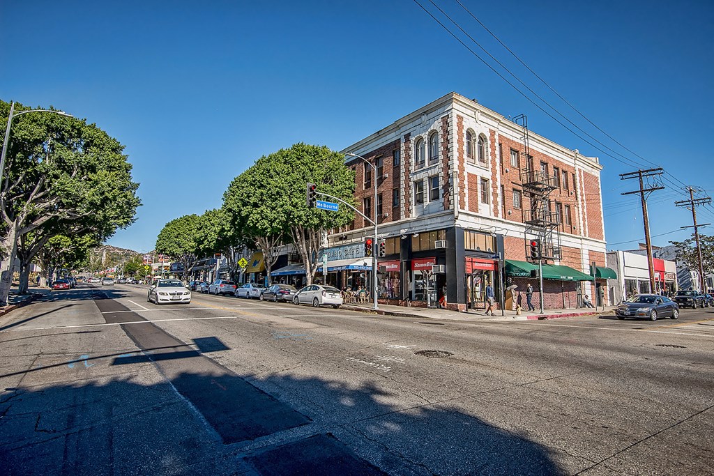 a city street with a building and cars on it