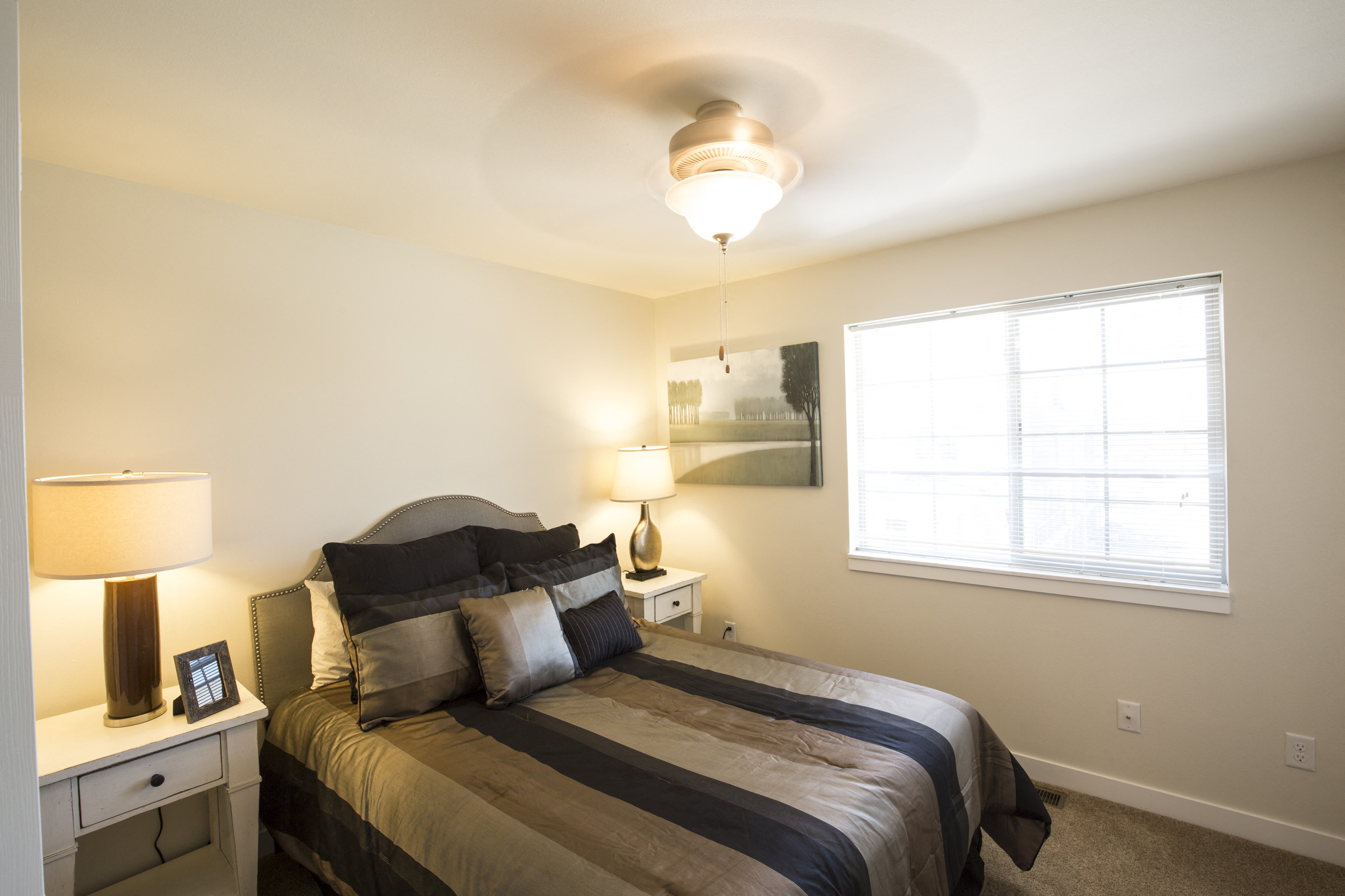 Image of bedroom containing one overhead light and window