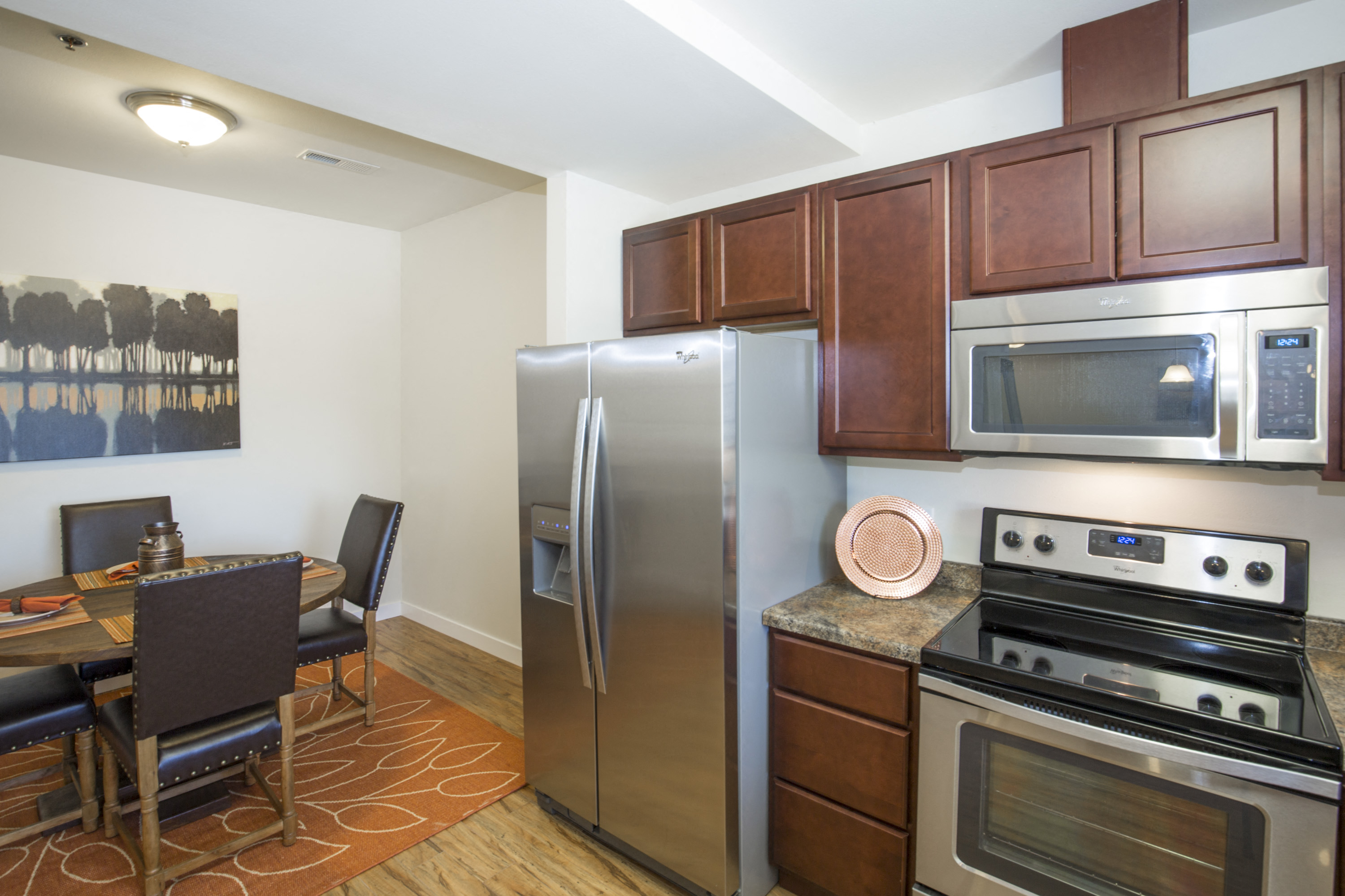 Image of stove, refrigerator, microwave and cabinets