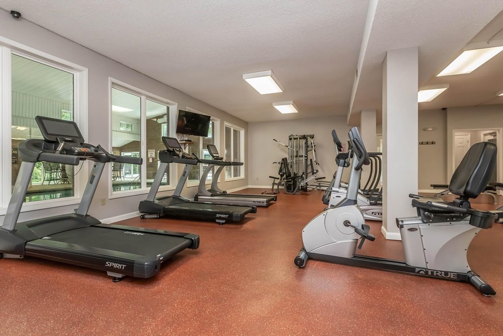 A gym with treadmills and exercise bikes.