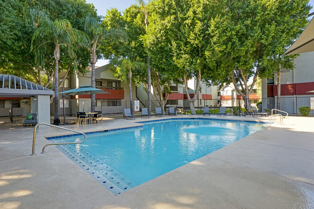 a swimming pool at a hotel with palm trees