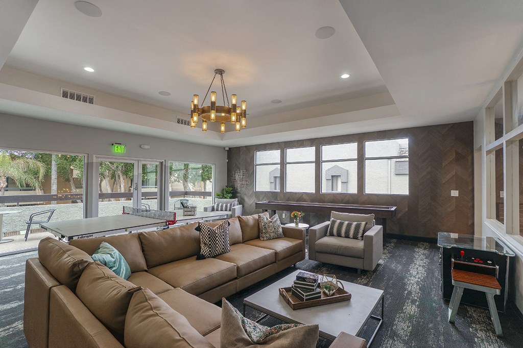 a large living room with a pool table and couches